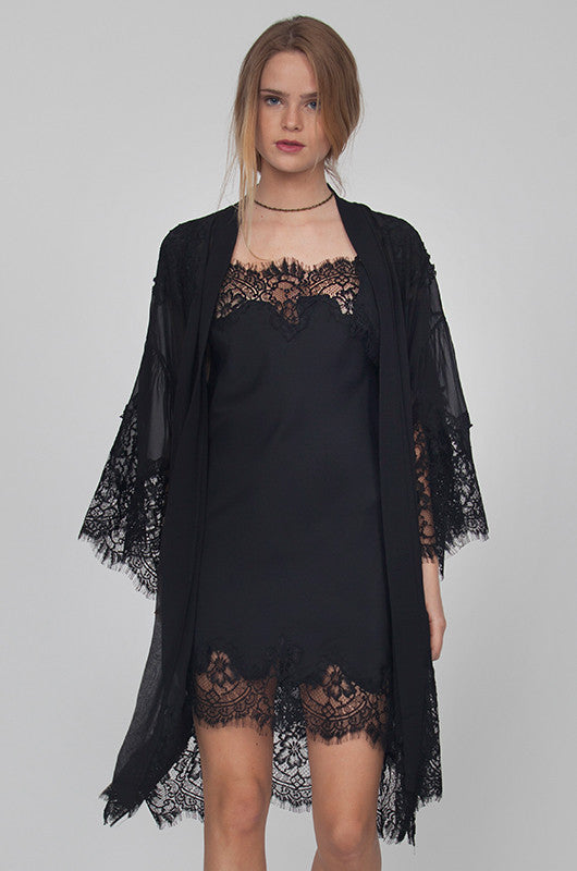 Model is wearing the Coco Lace Silk Kimono in black, opened, with the Coco Lace Silk Tunic in black underneath.