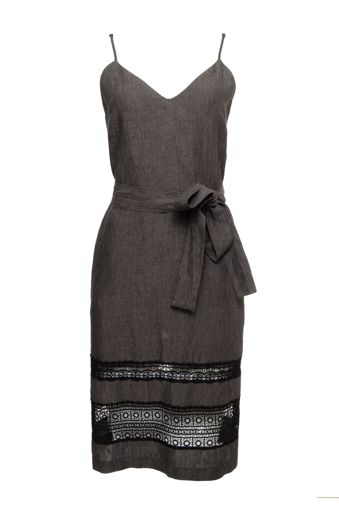 The Capri Linen Slip Dress in black, with matching sash worn around the waist.