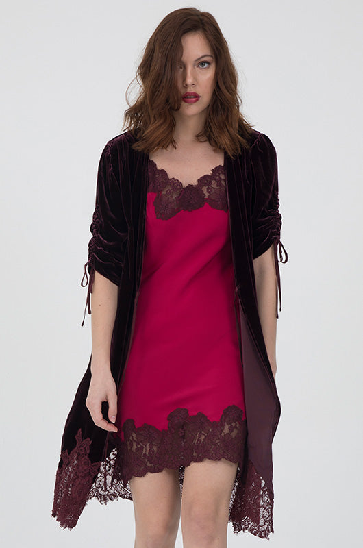 Model is wearing the Marilyn Lace Silk Slip Dress in fuchsia with burgundy lace and a burgundy velvet robe.