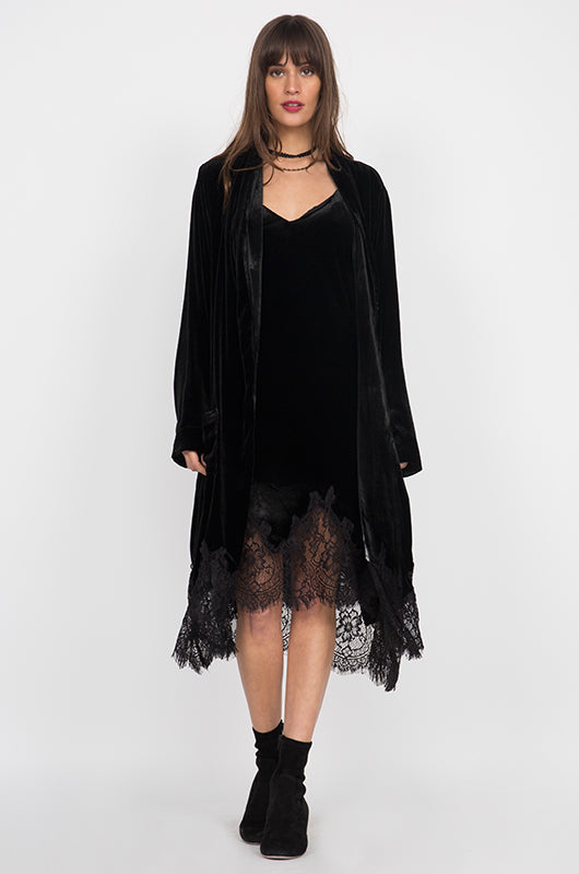 Model is wearing the Anastasia Lace Velvet Robe in black with the Coco Lace Velvet Dress in black and black high heel boots.