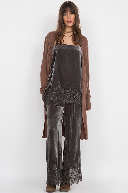 Model is wearing the Anastasia Lace Velvet Pant in pewter with the Anastasia Lace Velvet Cami in pewter and with a brown, knee length open cardigan.