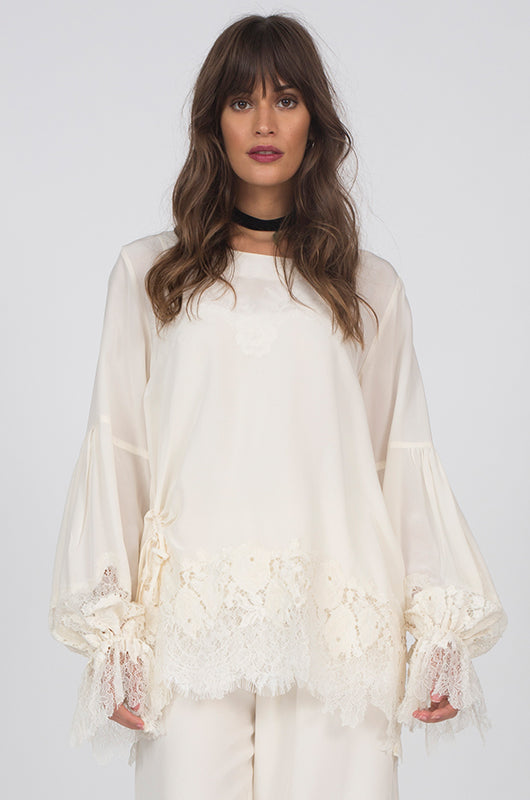 Model is wearing the Romantic Lace Sleeve Silk Top in white with the Julia Lace Silk Pants in dove.