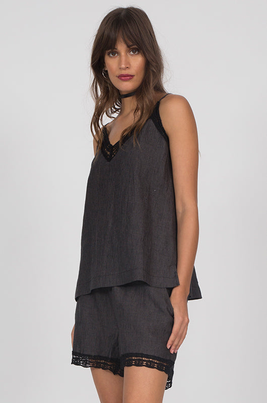 Model is wearing the Capri Linen Cami in black with Linen Capri Shorts in black.