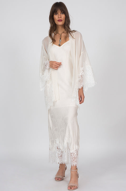Model is wearing the Emma Silk Jacquard Slip Dress in dove with the Coco Silk Lace Kimono in dove. Also worn with open toe, ankle strap, nude colored high heels.