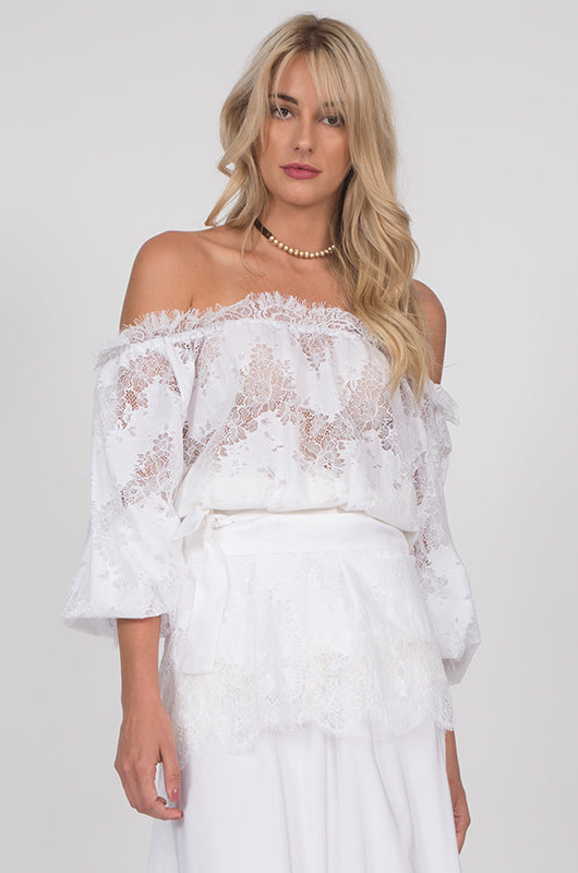Model is wearing the Suzy Zig Zag Lace Belted Top in white with the Wide Leg Linen Belted Pants in white.