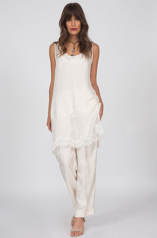 Model is wearing the Sheer Silk Tank Top in white, worn without the matching sash, along with the Floral Lace Silk Cami in white underneath. Also worn with the Silk Twill Piping Pants in dove.
