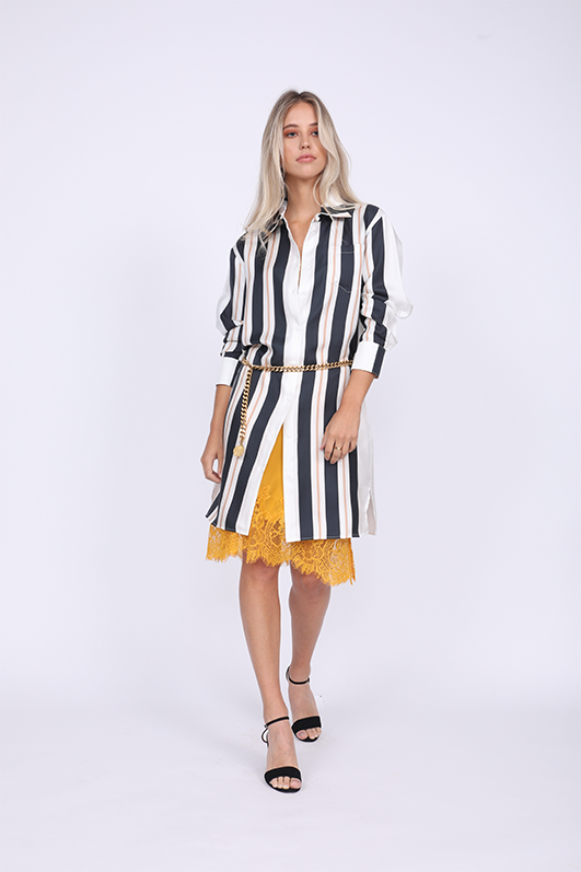 Model is wearing the Bold Stripe Sleeve Dress in black, mostly buttoned, with the Coco Lace Bodice Lace Dress in gold underneath and a gold chain used as belt. Also worn with black, ankle strap, open toe high heels.