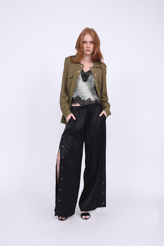 Model is wearing the Python Silk Print Racerback Lace Cami in grey python with the Tencel Western Shirt in dark olive and the Hayley Wide Leg Snap Pant in black, with the snaps undone up to above the knee. Worn with open toe, ankle strap, black high heels.