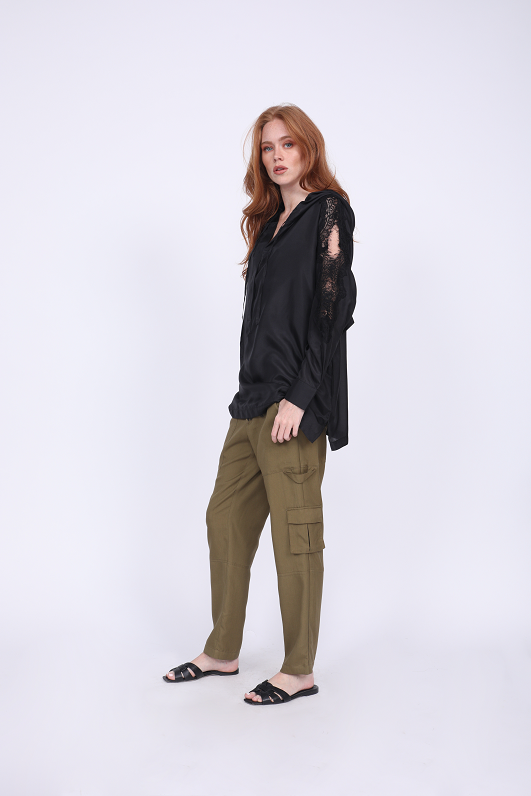 Model is wearing the Lace Cut Out Shoulder Top in black with the Tencel Cargo Pant in olive. Also worn with black, open toe, slip in flat sandals.