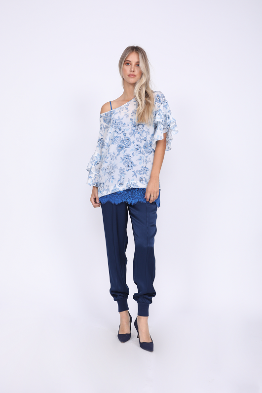Model is wearing the Hayley Jogger in navy with the Provence Ruffle Sleeve Tee in navy provence toile and the Coco Lace Silk Cami in french blue underneath. Also worn with blue suede pointed toe kitten heels.